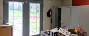 Kitchen area with storage cabinets and double doors