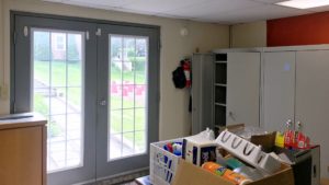 Kitchen area with storage cabinets and double doors