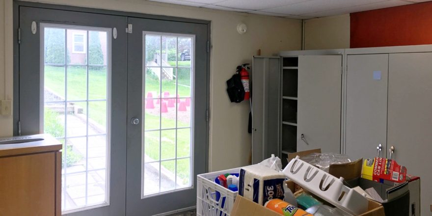 Kitchen area with storage cabinets and double doors