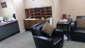 Waiting area with chairs and mailbox