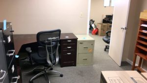 Office space with furniture and boxes