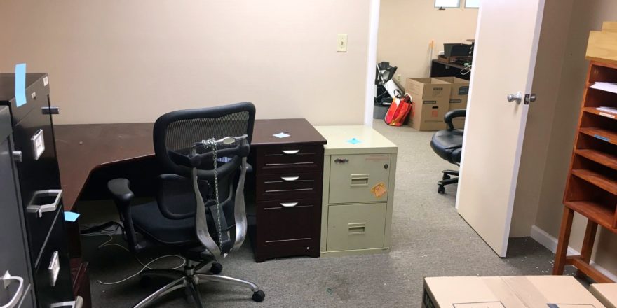 Office space with furniture and boxes