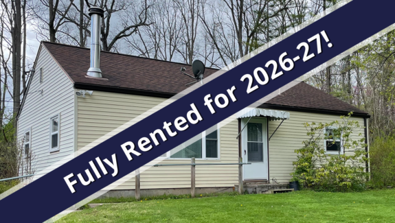 a house with a blue ribbon in front of it
