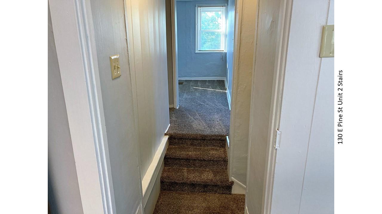 Staircase leading to a room at 130 E. Pine St.