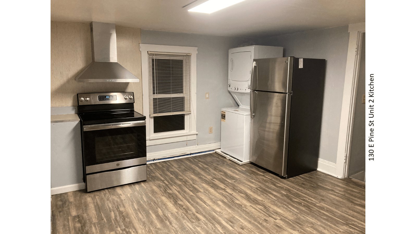 Kitchen with stove, refrigerator, washer, dryer.
