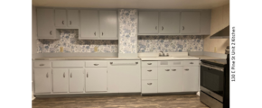 Kitchen with LVP flooring, stainless steel oven, and counter and cabinet space