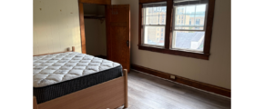 a bed room with a bed and a window