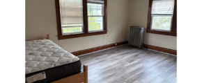 a bedroom with a bed and a radiator in it