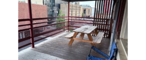 a wooden bench sitting on top of a wooden deck