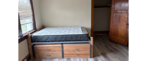 a bedroom with a bed and a dresser