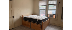 a bedroom with a bed and a window