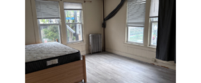 a bed room with a bed a window and a radiator