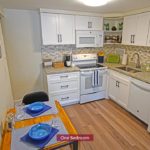 Kitchen with dining table, range oven, microwave, dishwasher, and refridgerator
