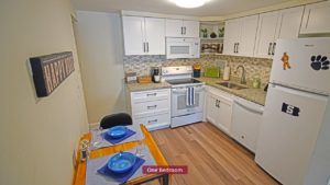 Kitchen with dining table, range oven, microwave, dishwasher, and refridgerator