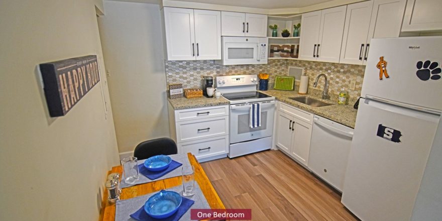 Kitchen with dining table, range oven, microwave, dishwasher, and refridgerator