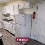 Galley kitchen with range oven, microwave, dishwasher, and refridgerator