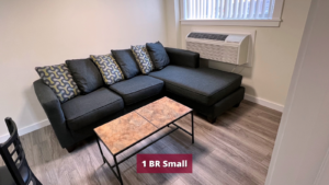 Living room with sectional couch, dining table, and coffee table