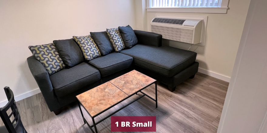 Living room with sectional couch, dining table, and coffee table