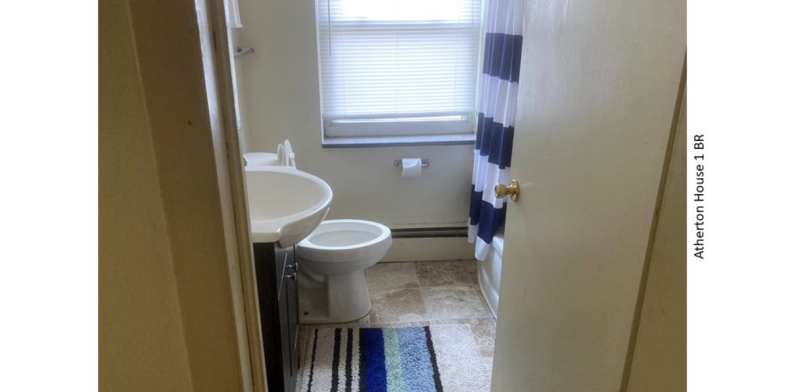 Bathroom with tub/shower combo, toilet, and vanity