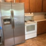 Kitchen with fridge and range oven