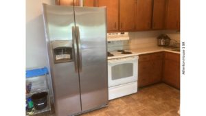 Kitchen with fridge and range oven