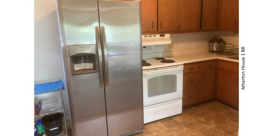 Kitchen with fridge and range oven