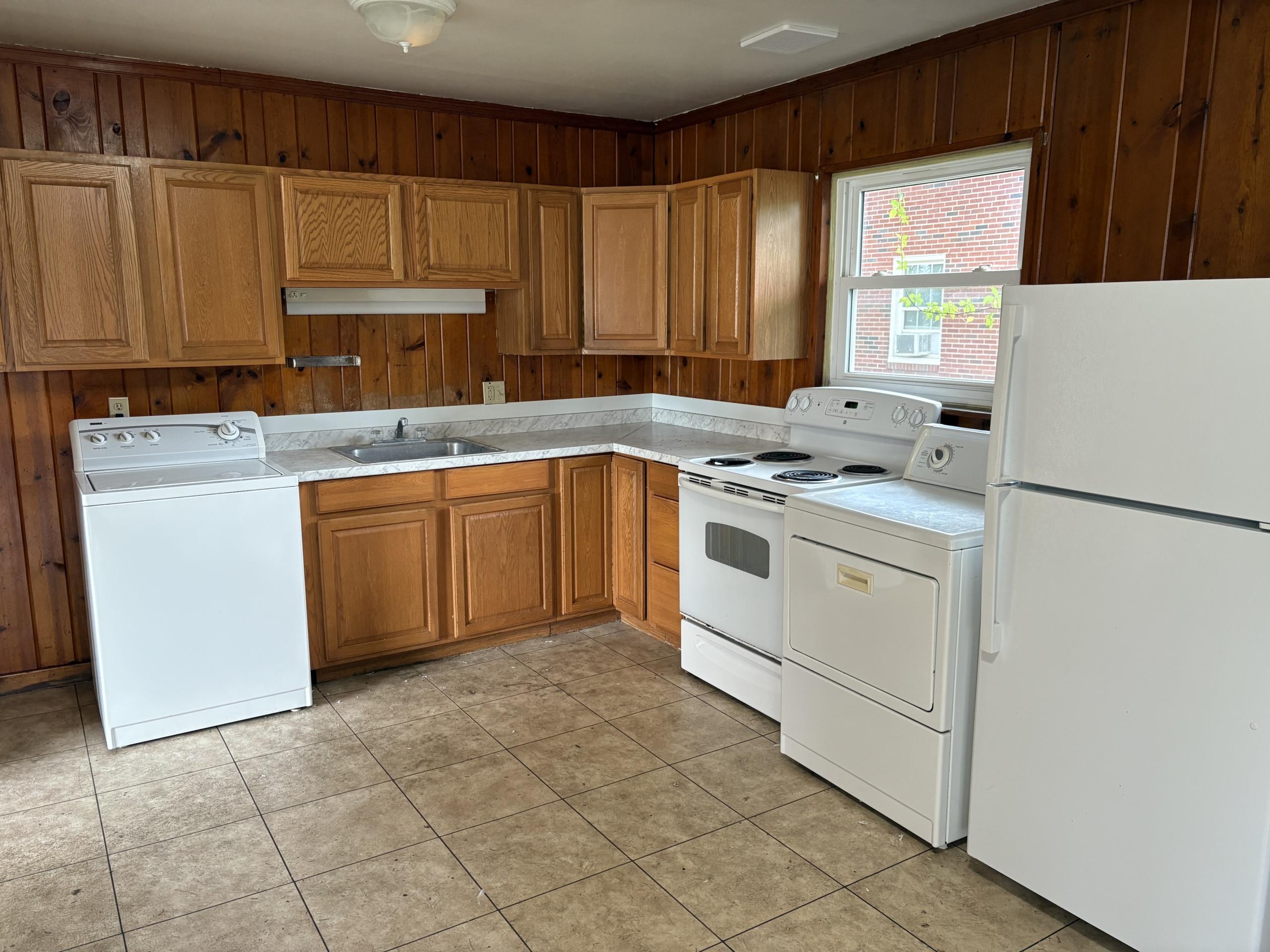 Kitchen with white appliances and wood cabinets