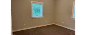 a empty room with a window and a ceiling fan