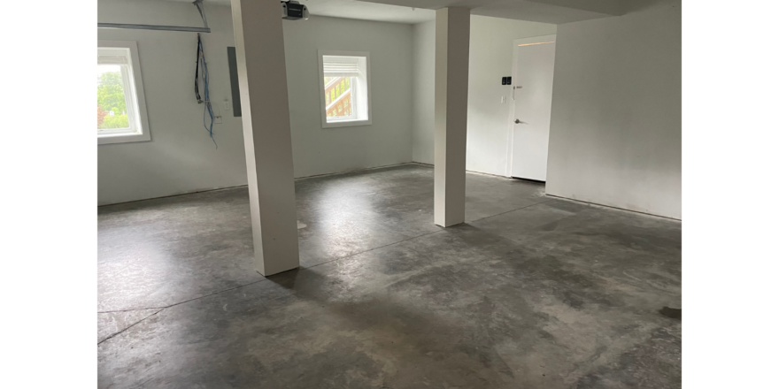 an empty room with white walls and floors