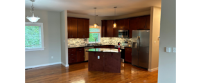 a large kitchen with a center island in the middle of the room