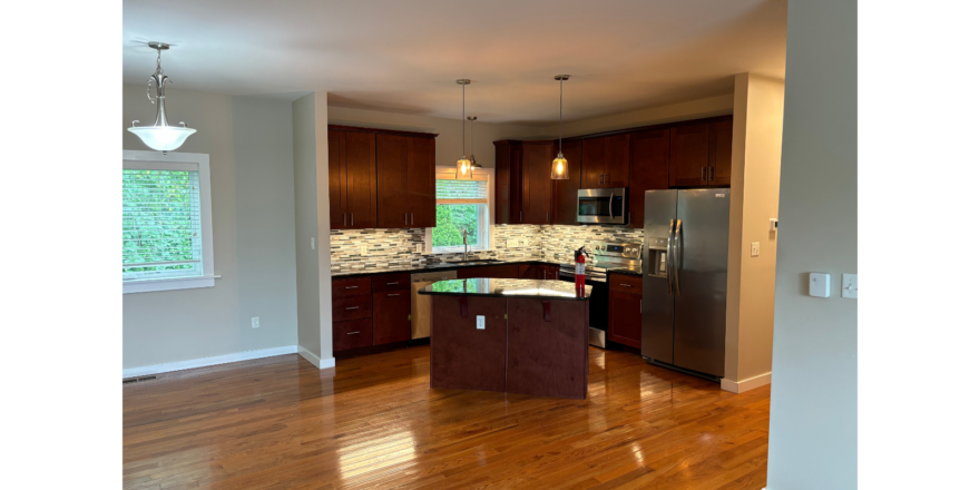 a large kitchen with a center island in the middle of the room