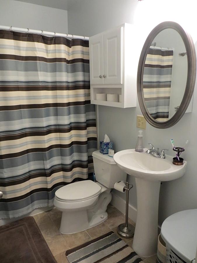 Small bathroom with striped shower curtain
