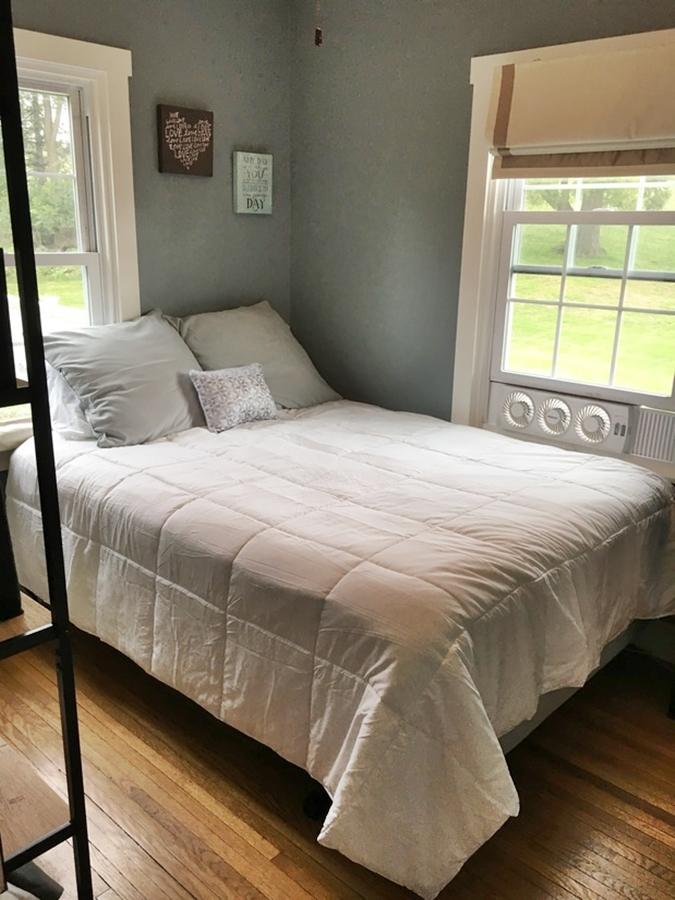 Cozy bedroom with a white comforter.