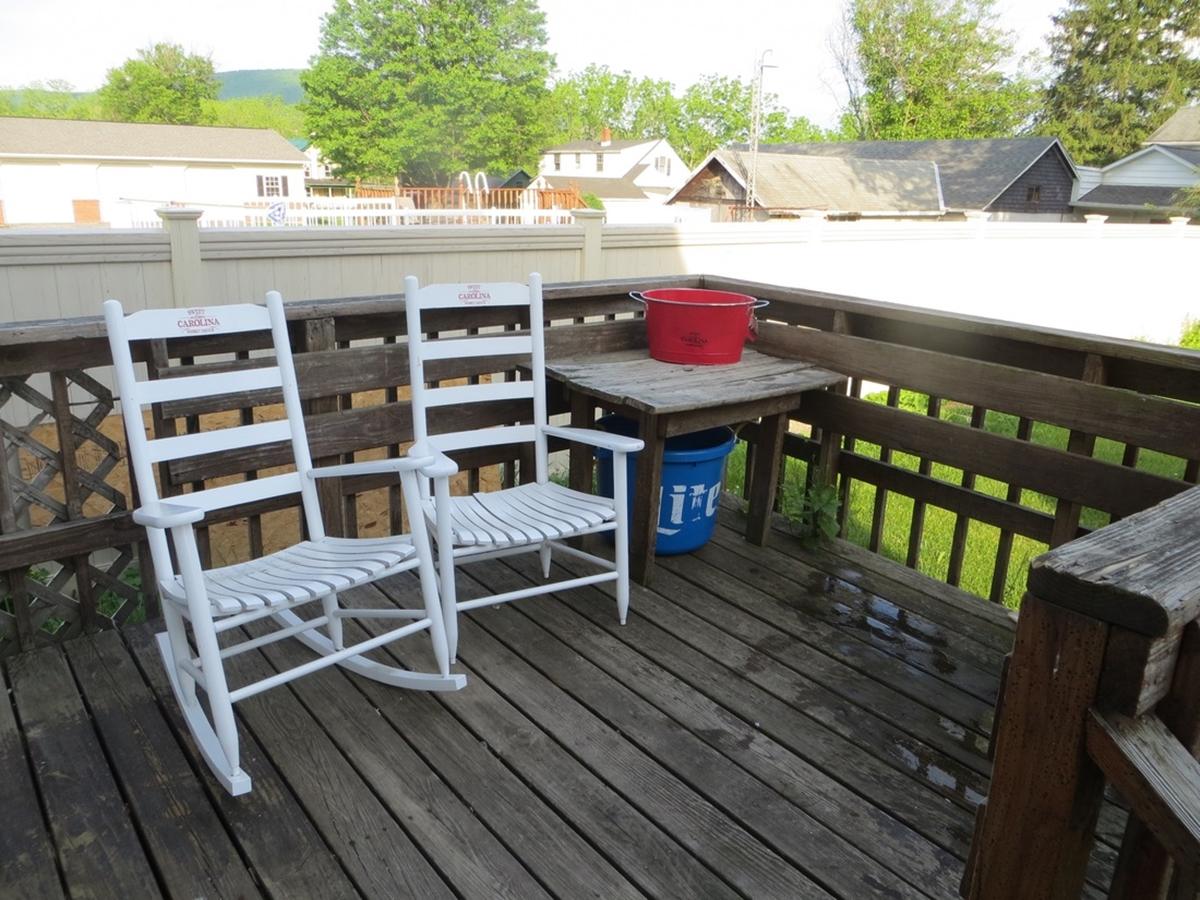 White rocking chairs on wooden deck