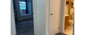 a hallway leading to a bathroom with a toilet