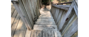 a wooden walkway going up to the top of a hill