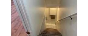a stairway leading up to a toilet in a bathroom