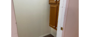 a door is open to a small bathroom