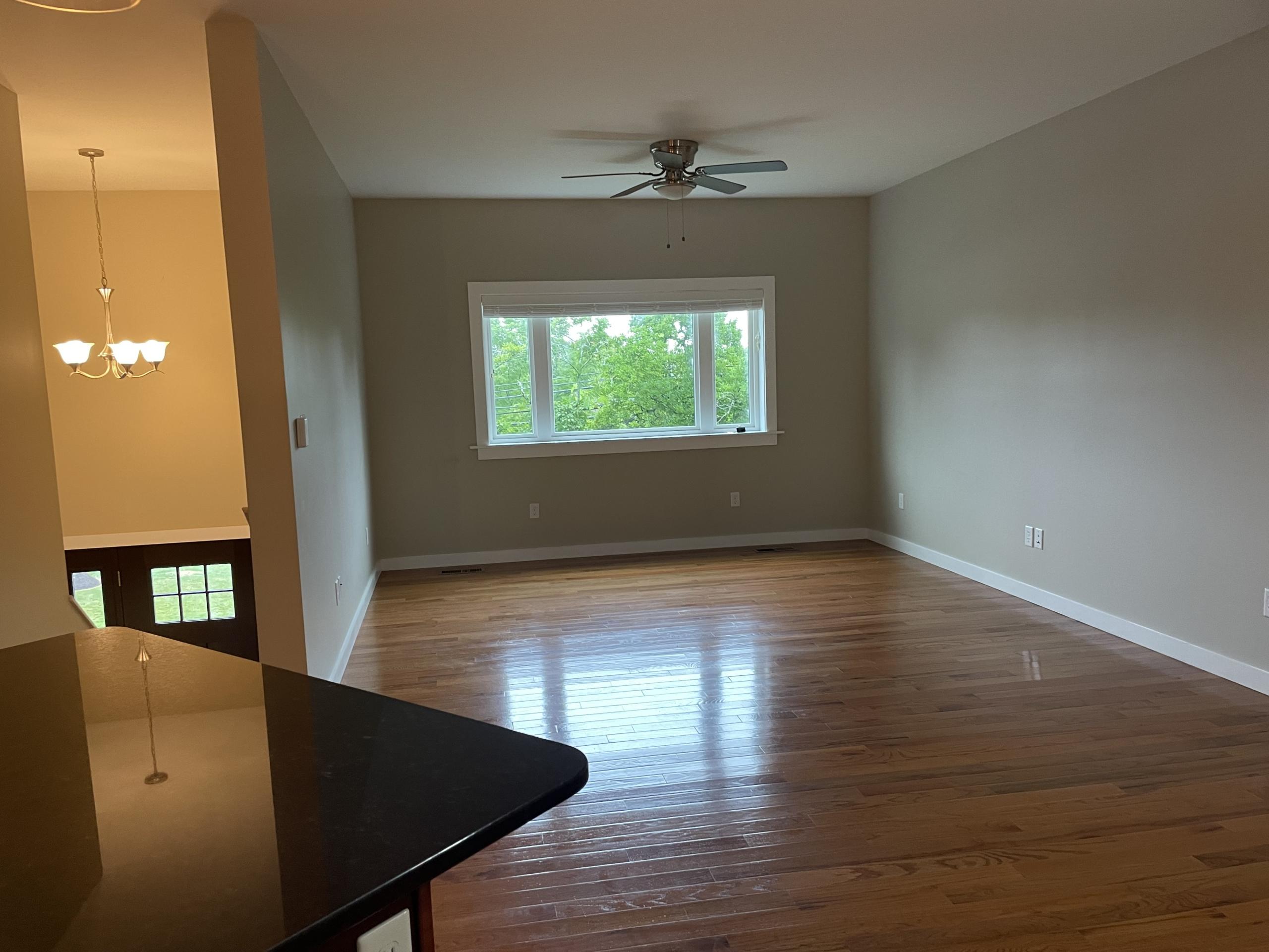 Living room with hardwood floors and large window