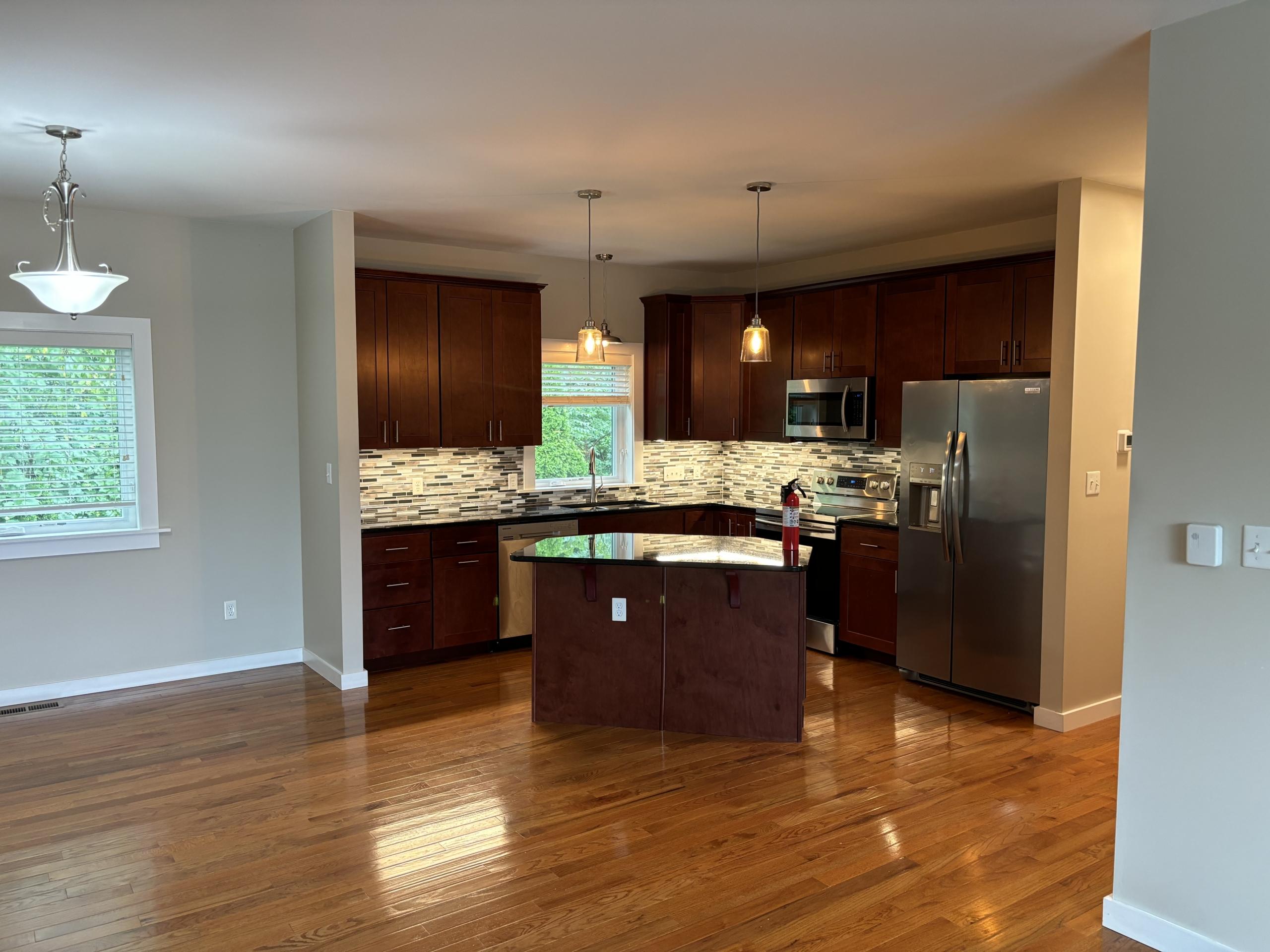 Modern kitchen with dark wood cabinets and island
