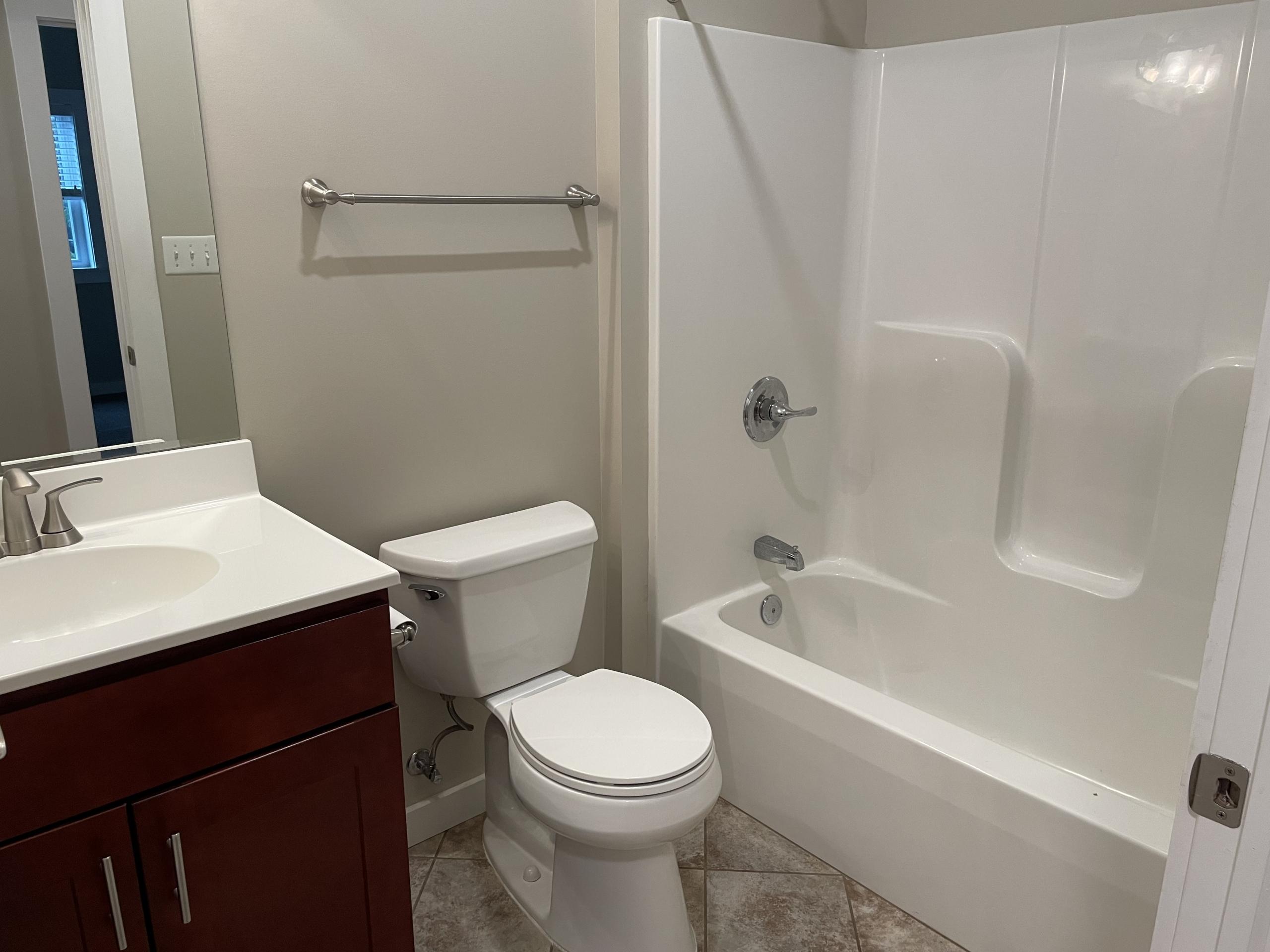 Modern bathroom with white tub and vanity