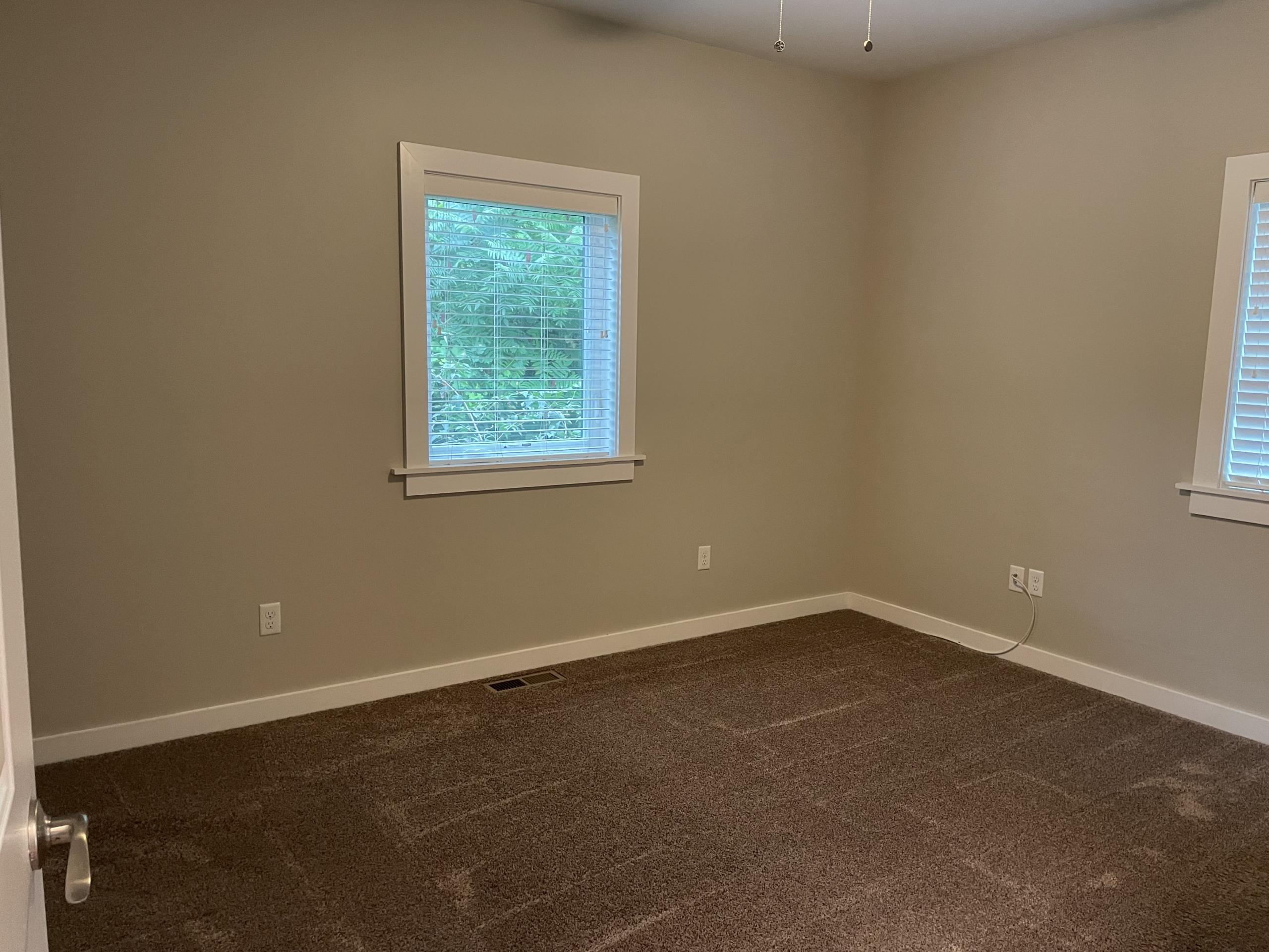 Empty bedroom with carpet and window