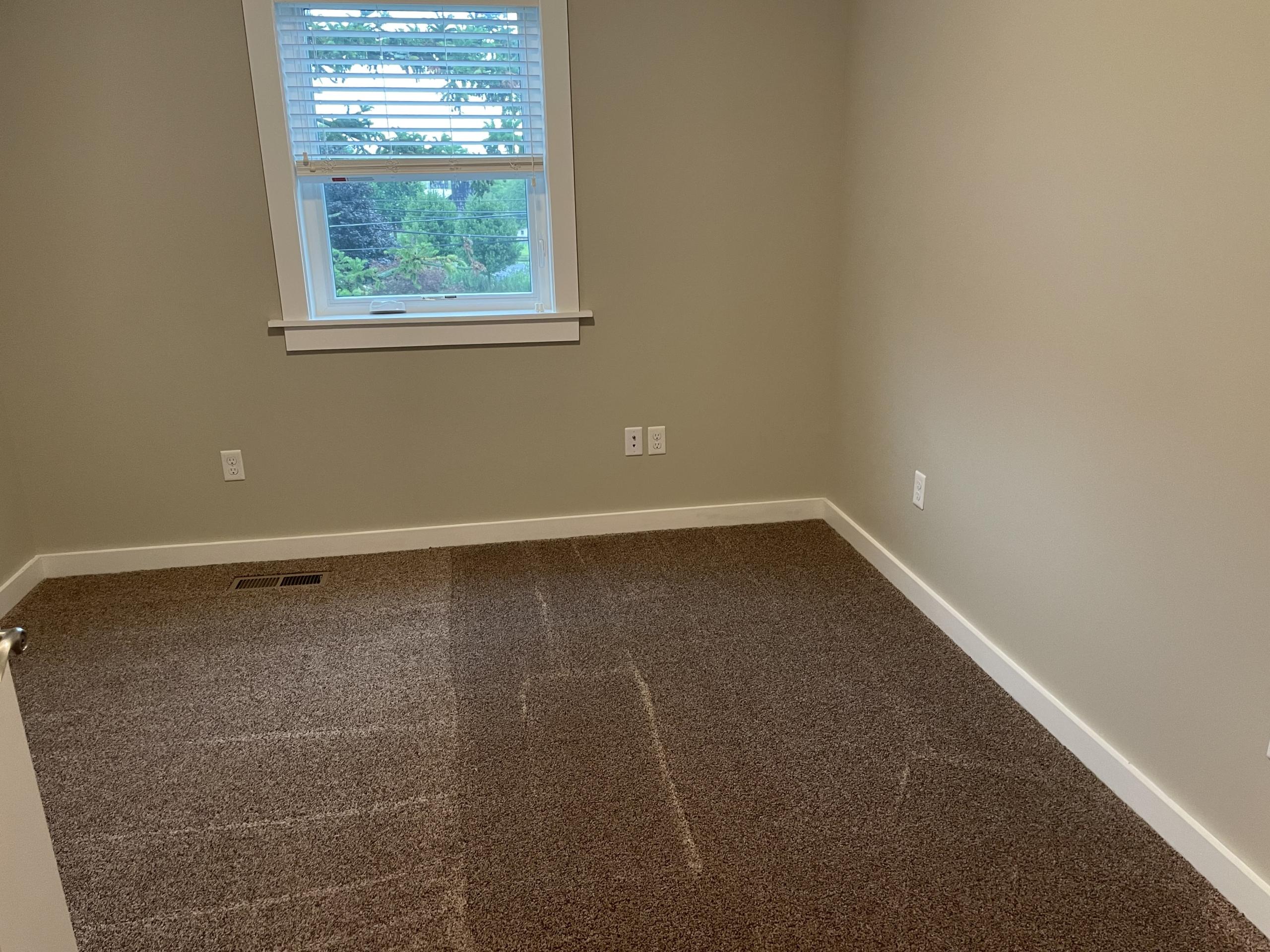 Empty room with carpet and window
