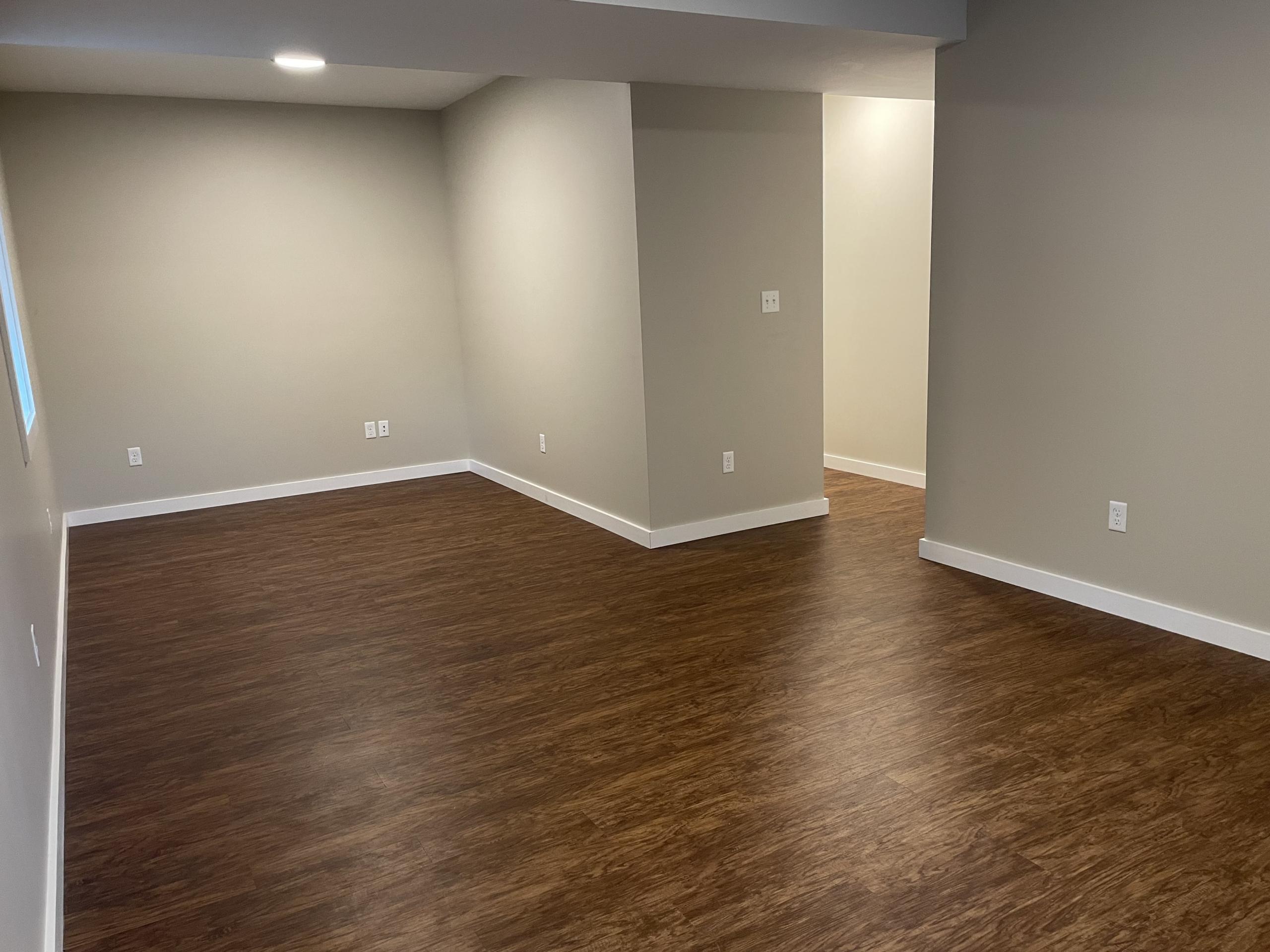 Empty living room with wood floors
