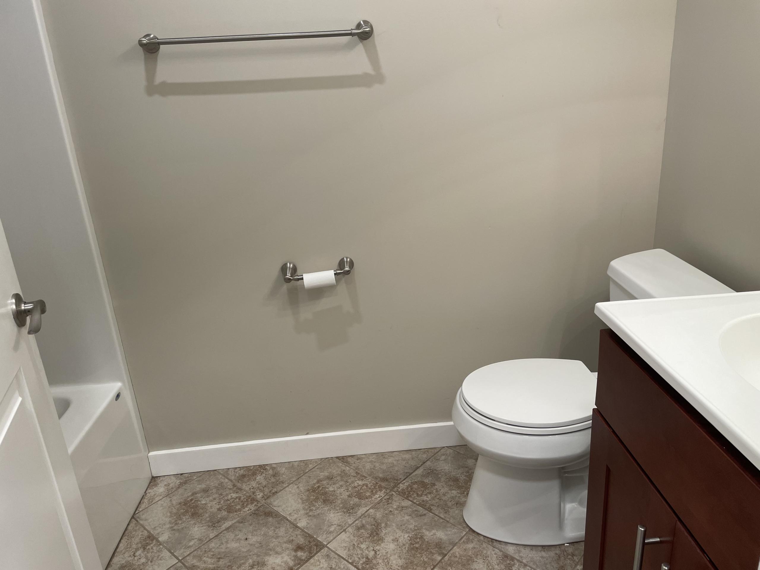 Bathroom with toilet, sink, and tub