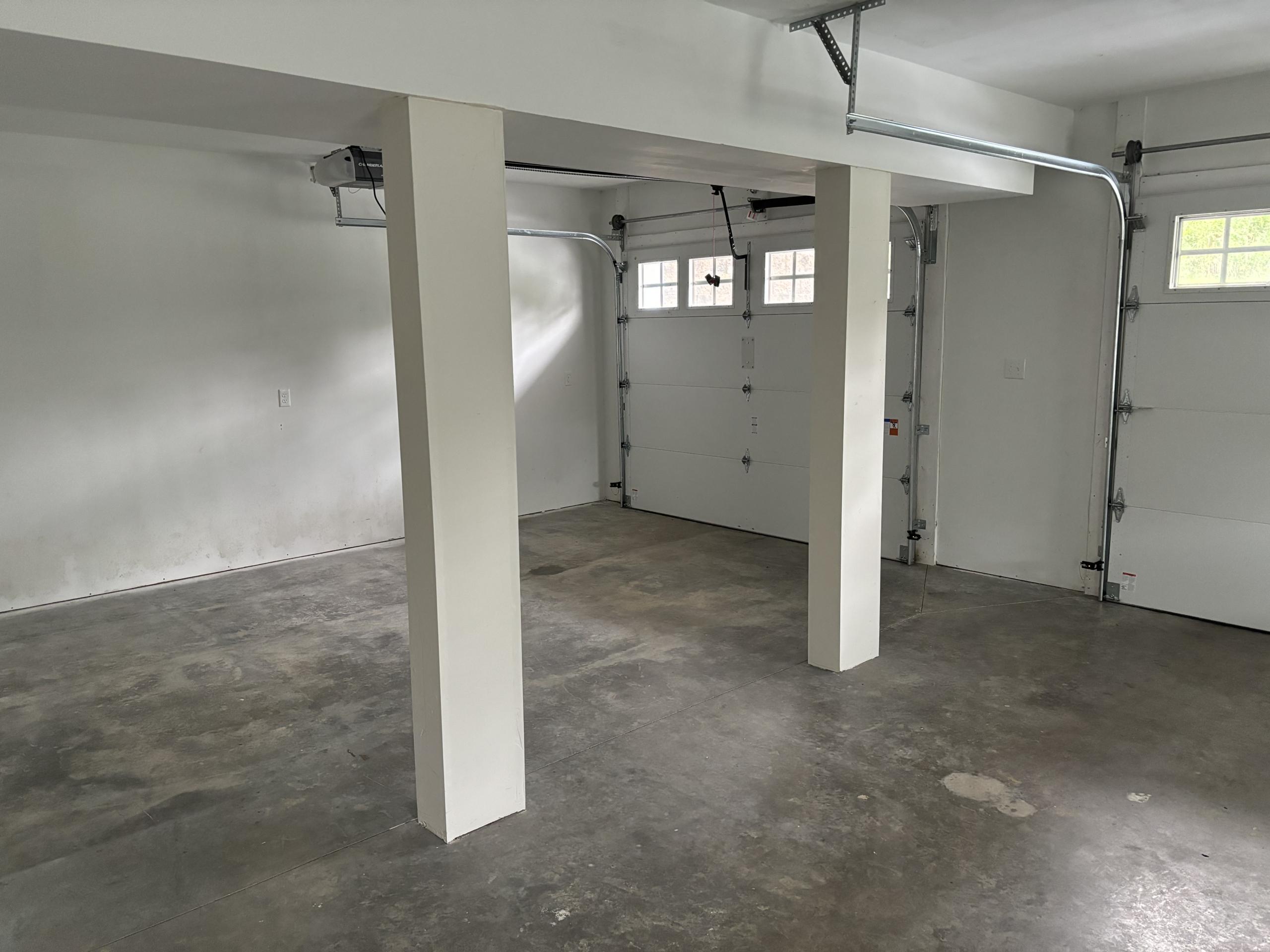 Empty garage with white walls and doors