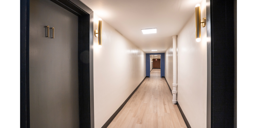 a long hallway with two lights on either side