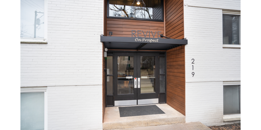 the entrance to a building with a sign on it