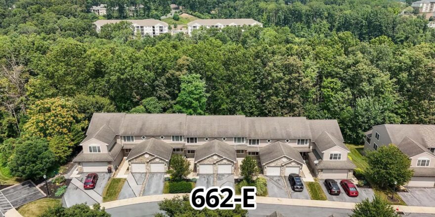 an aerial view of a large home surrounded by trees