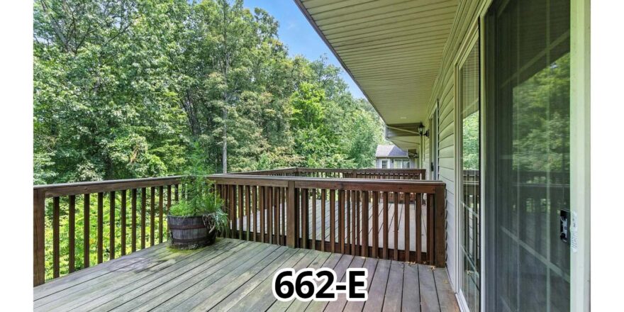 a porch with a wooden deck and a door